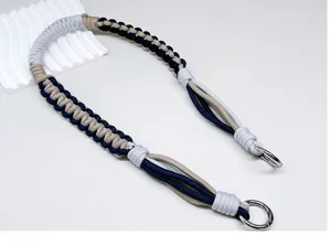 Gedetailleerd aanzicht van de handgemaakte gevlochten paracord tasriem met zilveren metalen ringen