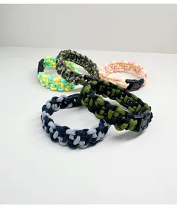 Detailed macro view of colorful hand-woven paracord survival bracelets with buckles.
