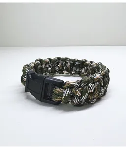 Detailed view of handmade camouflage paracord survival bracelet with plastic buckle