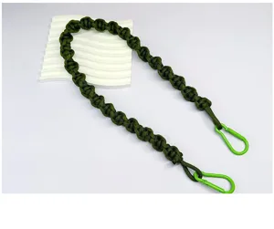Detailed view of a hand-woven army green braided rope strap for bags or cameras.