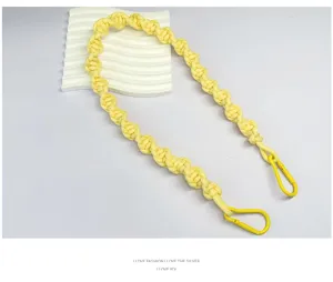 Close-up of yellow hand-woven spiral rope bag strap with matching yellow carabiners