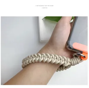 Detailed macro view of a stylish handmade woven paracord wrist strap for phones and cameras