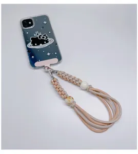 Cordon de téléphone tressé à la main couleur pêche et beige avec perles décoratives.