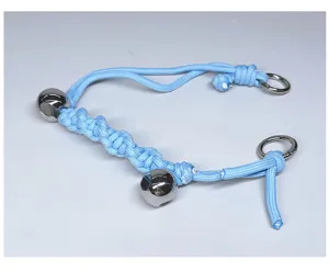 Macro detail view of light blue handmade braided bag handle with shiny silver metal beads