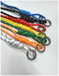 Detail view of seven colorful handmade braided rope charms with silver metal rings