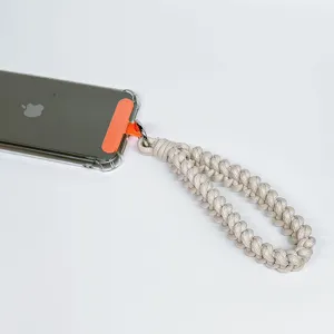 Handmade braided phone wrist strap lanyard with anti-loss connector patch in beige.