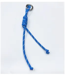 Macro detail of the blue handcrafted braided rope charm featuring a silver ring.