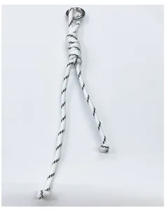 Close-up macro detail of handmade white and black woven rope charm with silver metal ring