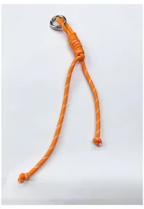 Detail view of the orange braided rope bag charm with a silver metal ring.