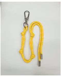 Close-up detail of a bright yellow braided rope lanyard featuring a silver carabiner clasp