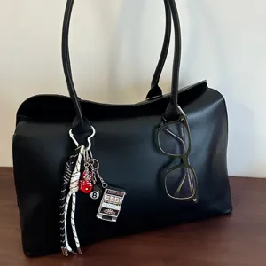 Hand-woven colorful rope bag charm featuring decorative red dice, 8-ball and mini slot machine.