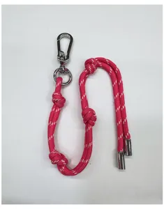 Pink braided rope bag charm with silver carabiner and decorative knots for accessories