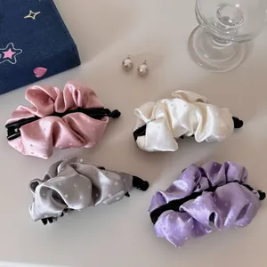 Selection of four satin pleated banana hair clips in assorted pastel colors with polka dots