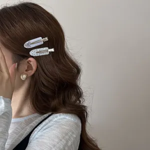 Close-up of elegant Korean style acrylic bow hair clips worn on the side