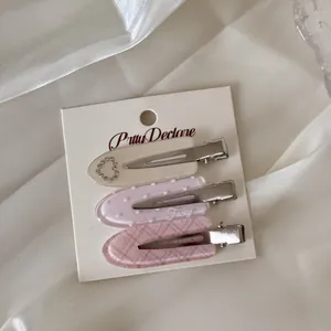 Set of 3 acrylic duckbill hair clips featuring heart patterns and rhinestone accents