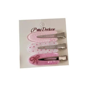 Set of 3 pink Korean style acrylic hair clips featuring elegant bow and floral designs