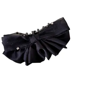Elegant black satin bow banana clip for French-style high ponytail hairstyles.