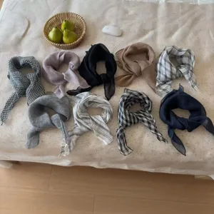 Collection of breathable linen scarves in various colors and check patterns.