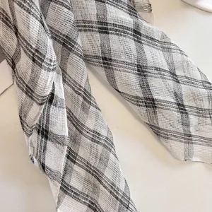 Close-up detail showing the breathable 100% pure linen black and white checkered fabric