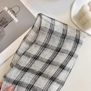 Close-up of 100% pure linen square scarf with classic black and white plaid pattern