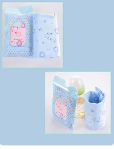 Detailed view of the USB baby bottle warmer sleeve in blue with packaging and bottle