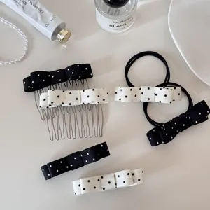 Detail view of black and white polka dot bow hair clips, combs, and hair ties