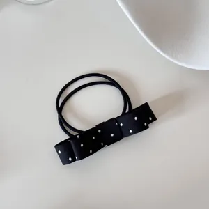 Elegant black and white polka dot bow hair tie featuring double elastic bands for women