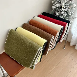 Detail view of colorful mohair scarves with decorative whipstitch edges for winter.