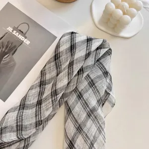 Detail shot of the breathable 100% pure linen plaid scarf for women