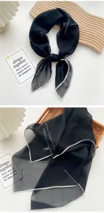 Detailed view of a semi-transparent black square silk scarf with white stitched edges