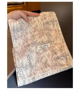 Detail showing the elegant floral pattern and texture of the cotton linen square scarf