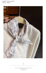 Detailed close-up of a floral cotton linen square scarf tied on a fluffy white sweater