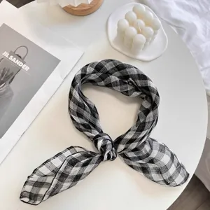 Close-up of black and white checkered linen square scarf tied in a neat knot