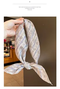 Close-up of the cotton-linen headscarf featuring a blue and beige striped pattern