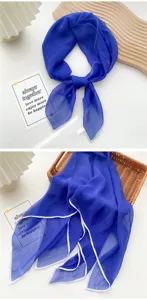 Detailed macro view of vibrant royal blue thin silk square scarf with white trim