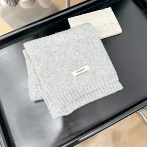 Detailed view of a premium 100% gray wool knitted scarf for winter fashion and warmth.