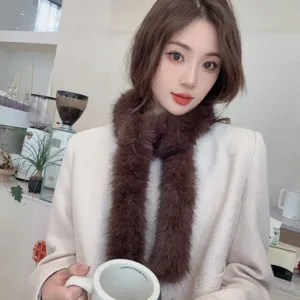 Close-up of a soft brown plush skinny scarf worn by a model in a cozy cafe setting.