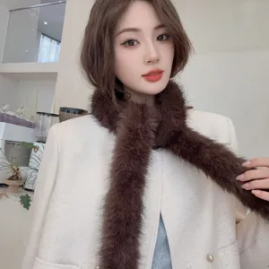 Detail showing the soft texture of a brown plush thin scarf for winter warmth.