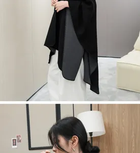 Detail of a premium black and grey shawl cape jacket showing soft fabric and drape