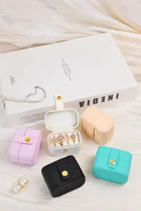 Compact travel ring boxes in multiple colors featuring soft velvet interior and snap closure