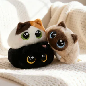 Trio of adorable chubby round plush cat toys stacked together on a soft knitted white blanket
