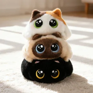 Stack of three soft and chubby plush cat toys with big eyes on a fluffy white rug