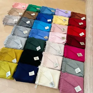 Top-down view of multi-color 100% Australian cashmere scarves with fringe details