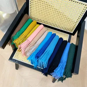 Variety of high-quality solid cashmere scarves with fringe details in multiple colors
