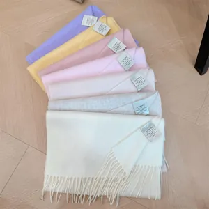 Detailed view showing a variety of 100% Australian wool scarves in soft pastel colors