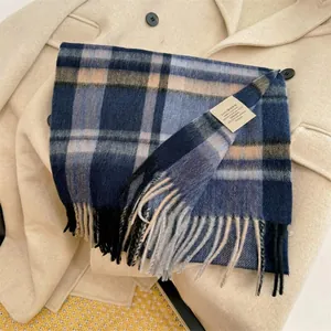 Close-up detail of a blue and beige 100% Australian wool plaid scarf with tassels