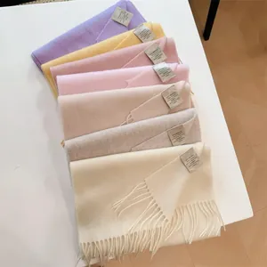 Detailed view of stacked 100% Australian wool scarves in assorted pastel colors