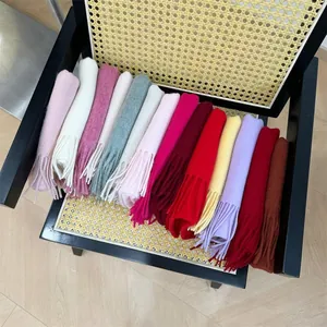 Close-up of 100% Australian cashmere scarves in multiple solid colors with tassels.