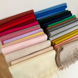 Variety of 100% Australian wool cashmere scarves in assorted solid colors with fringe details.