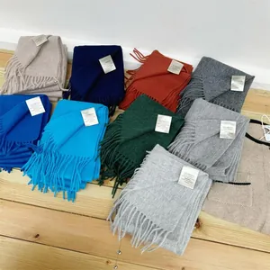 Showcase of various colors of 100% Australian wool solid scarves with fringed edges